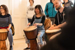 teambuilding-employee-looking-at-her-drum