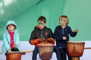 three-kids-with-face-paint-drumming